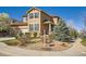 Two-story home featuring stucco and stone accents, a well-manicured yard, and a charming front porch at 20964 E Greenwood Pl, Aurora, CO 80013