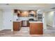 Updated kitchen with stainless steel appliances, island, and wooden cabinets at 20964 E Greenwood Pl, Aurora, CO 80013