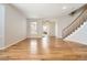 A spacious living room with gleaming hardwood floors and staircase in a neutrally painted home at 20964 E Greenwood Pl, Aurora, CO 80013