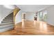 Spacious living room features gleaming hardwood floors, a grand staircase and abundant natural light through large windows at 20964 E Greenwood Pl, Aurora, CO 80013