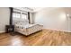 Comfortable main bedroom with large windows, hardwood floors, neutral paint and stylish, padded headboard at 20964 E Greenwood Pl, Aurora, CO 80013