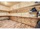 Unfinished storage room with multiple shelving and wood floors at 20964 E Greenwood Pl, Aurora, CO 80013