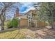 Exterior side view of the home featuring mature trees, and manicured landscaping at 14110 E Dickinson Dr # A, Aurora, CO 80014