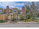Exterior of the home featuring brick chimneys, well-maintained landscaping, and a private yard at 14110 E Dickinson Dr # A, Aurora, CO 80014