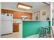 Eat-in kitchen features bright cabinets, white appliances and breakfast bar at 14110 E Dickinson Dr # A, Aurora, CO 80014