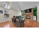 Living room with hardwood floors, vaulted ceilings, brick fireplace with mounted TV at 14110 E Dickinson Dr # A, Aurora, CO 80014
