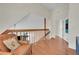 Loft area featuring wood floors, view of downstairs, and lots of light at 14110 E Dickinson Dr # A, Aurora, CO 80014