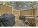 Relaxing patio with wooden deck, grill, table, and chairs surrounded by a privacy fence at 14110 E Dickinson Dr # A, Aurora, CO 80014