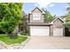 Charming two-story home boasts a two-car garage and attractive facade with manicured landscaping at 4756 E Pinewood Cir, Centennial, CO 80121