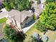 Backyard view features a stone patio and lush lawn, enclosed by a wood fence and mature trees at 16690 Amberstone Way, Parker, CO 80134