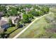 Aerial view of a tree-lined neighborhood showcasing a paved walking path beside well-manicured lawns at 16690 Amberstone Way, Parker, CO 80134