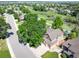 An aerial view reveals a home nestled in a neighborhood with mature trees and a tranquil walking trail at 16690 Amberstone Way, Parker, CO 80134