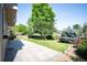 Beautifully landscaped backyard with stone patio, lawn, trees and shrubbery at 16690 Amberstone Way, Parker, CO 80134