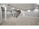 Spacious finished basement with staircase, neutral paint, recessed lighting, and new carpet at 16690 Amberstone Way, Parker, CO 80134