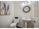 Powder bathroom with a pedestal sink, decorative mirror, and neutral finishes at 16690 Amberstone Way, Parker, CO 80134