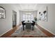 Elegant dining room with hardwood floors, a modern chandelier, and stylish blue chairs at 16690 Amberstone Way, Parker, CO 80134