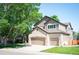 Two-story home boasts a two-car garage, a combination of brick and siding, and well-manicured landscaping at 16690 Amberstone Way, Parker, CO 80134