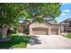 Charming home featuring a brick facade, three-car garage, and a lovely, mature tree in the front yard at 16690 Amberstone Way, Parker, CO 80134