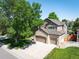 Attractive home with two-car garage and brick accents, complemented by mature landscaping and a well-maintained lawn at 16690 Amberstone Way, Parker, CO 80134