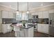 Well-lit kitchen with modern stainless steel appliances, a center island, and ample storage at 16690 Amberstone Way, Parker, CO 80134