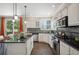 Updated kitchen features sleek appliances, dark countertops and a bright view to the backyard at 16690 Amberstone Way, Parker, CO 80134
