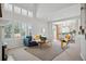 Bright living room with large windows, neutral colors, and a cozy seating area next to the fireplace at 16690 Amberstone Way, Parker, CO 80134