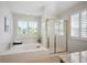 Bright main bathroom with tub, shower, and plenty of natural light from the windows at 16690 Amberstone Way, Parker, CO 80134
