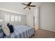 Comfortable bedroom featuring a ceiling fan, and bright windows with plantation shutters at 16690 Amberstone Way, Parker, CO 80134