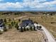 Contemporary home with a metal roof, expansive windows, and a large driveway on a spacious lot with mountain views at 8263 Merryvale Trl, Parker, CO 80138