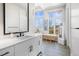 Contemporary bathroom with white vanity and large mirror at 8263 Merryvale Trl, Parker, CO 80138