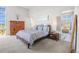 Spacious primary bedroom with wood furniture and large windows at 8263 Merryvale Trl, Parker, CO 80138