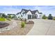 Modern farmhouse with a three car garage, long driveway and beautiful landscaping at 8263 Merryvale Trl, Parker, CO 80138