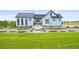 Beautifully landscaped front yard with green lawn and modern farmhouse elevation at 8263 Merryvale Trl, Parker, CO 80138