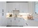 White kitchen features a coffee bar and extra counter space at 8263 Merryvale Trl, Parker, CO 80138