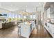 Open concept kitchen with white cabinets, large island, and stainless steel appliances at 8263 Merryvale Trl, Parker, CO 80138