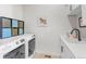 Bright laundry room with modern washer and dryer at 8263 Merryvale Trl, Parker, CO 80138