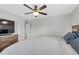 Spacious main bedroom with a ceiling fan, hardwood floors, and a wooden bed frame at 1185 Xanthia St, Denver, CO 80220