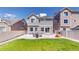 Well-maintained backyard with a grassy lawn, patio with seating, ideal for outdoor enjoyment and entertainment at 19000 E 55Th Ave, Denver, CO 80249