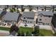 Aerial view of backyard featuring a patio, lush green lawn, and play equipment, ideal for outdoor activities at 19000 E 55Th Ave, Denver, CO 80249