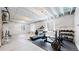 Spacious basement featuring exposed ceiling and workout equipment, providing ample space for exercise and recreation at 19000 E 55Th Ave, Denver, CO 80249