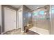 Modern bathroom with a glass shower, tiled walls, and ample lighting, offering a luxurious experience at 19000 E 55Th Ave, Denver, CO 80249