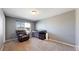 Comfortable bedroom with a recliner, crib, neutral walls, and ample natural light at 19000 E 55Th Ave, Denver, CO 80249