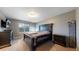 The main bedroom features a comfortable bed, neutral walls, and ample storage at 19000 E 55Th Ave, Denver, CO 80249