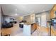 Modern kitchen with stainless steel appliances, breakfast bar, and seamless flow to living space at 19000 E 55Th Ave, Denver, CO 80249