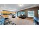 Open-concept living room with comfortable seating, a large window, and access to the kitchen at 19000 E 55Th Ave, Denver, CO 80249