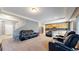 Open-concept living room with comfortable seating and access to the kitchen and staircase at 19000 E 55Th Ave, Denver, CO 80249