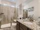 Modern bathroom boasts granite vanity, large shower, and updated fixtures at 8803 S Winnipeg Ct, Aurora, CO 80016