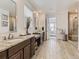 Bathroom with double vanity, granite countertop and walk-in shower at 8803 S Winnipeg Ct, Aurora, CO 80016