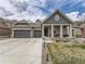 Two-story house with gray siding, stone accents, and a two-car garage at 8803 S Winnipeg Ct, Aurora, CO 80016