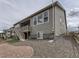 Gray siding house with a backyard deck and gravel landscaping at 8803 S Winnipeg Ct, Aurora, CO 80016